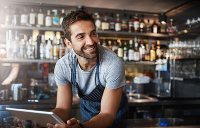 Buy stock photo Smile, thinking and a barista with a tablet at a cafe for online orders and communication. Happy, ideas and a male pub manager or bartender with technology for an app, connection and ordering stock