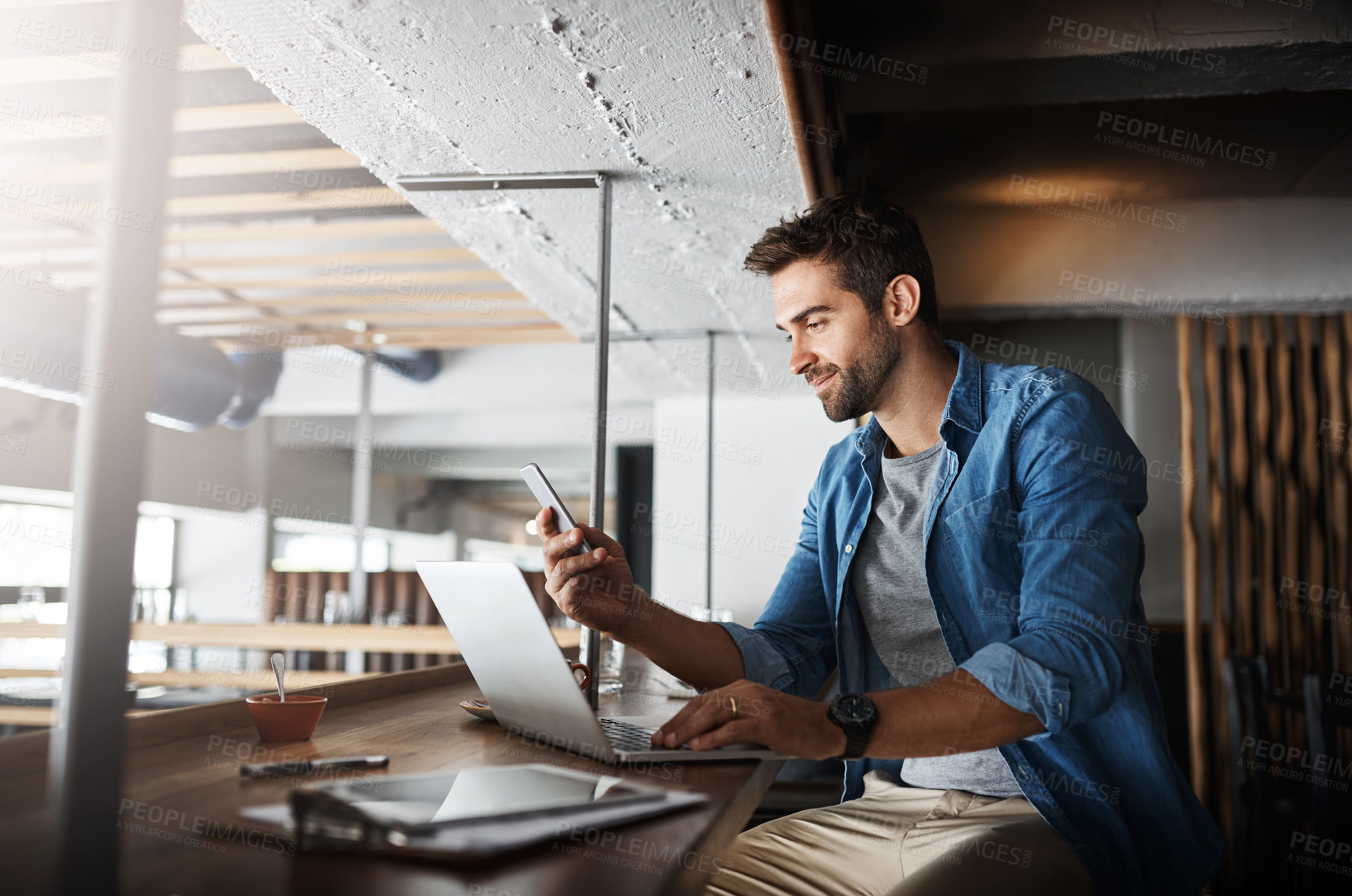 Buy stock photo Man in coffee shop, laptop and smartphone, small business and entrepreneur in hospitality industry and connect. Male owner, cafe franchise and check email or social media with digital admin on pc