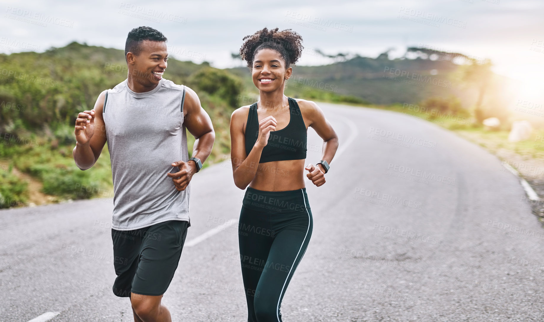 Buy stock photo Shot of a sporty young couple exercising together outdoors