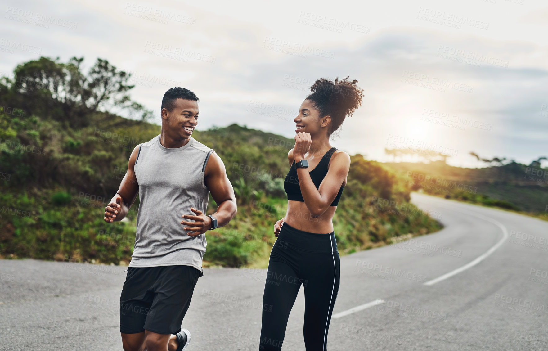 Buy stock photo Shot of a sporty young couple exercising together outdoors