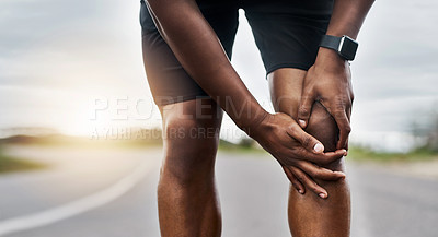Buy stock photo Closeup shot of a sporty man suffering with knee pain while exercising outdoors