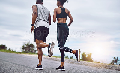 Buy stock photo Rearview shot of a sporty young couple exercising together outdoors