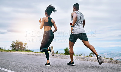 Buy stock photo Rearview shot of a sporty young couple exercising together outdoors