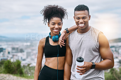 Buy stock photo Portrait of a sporty young couple taking a break while exercising outdoors