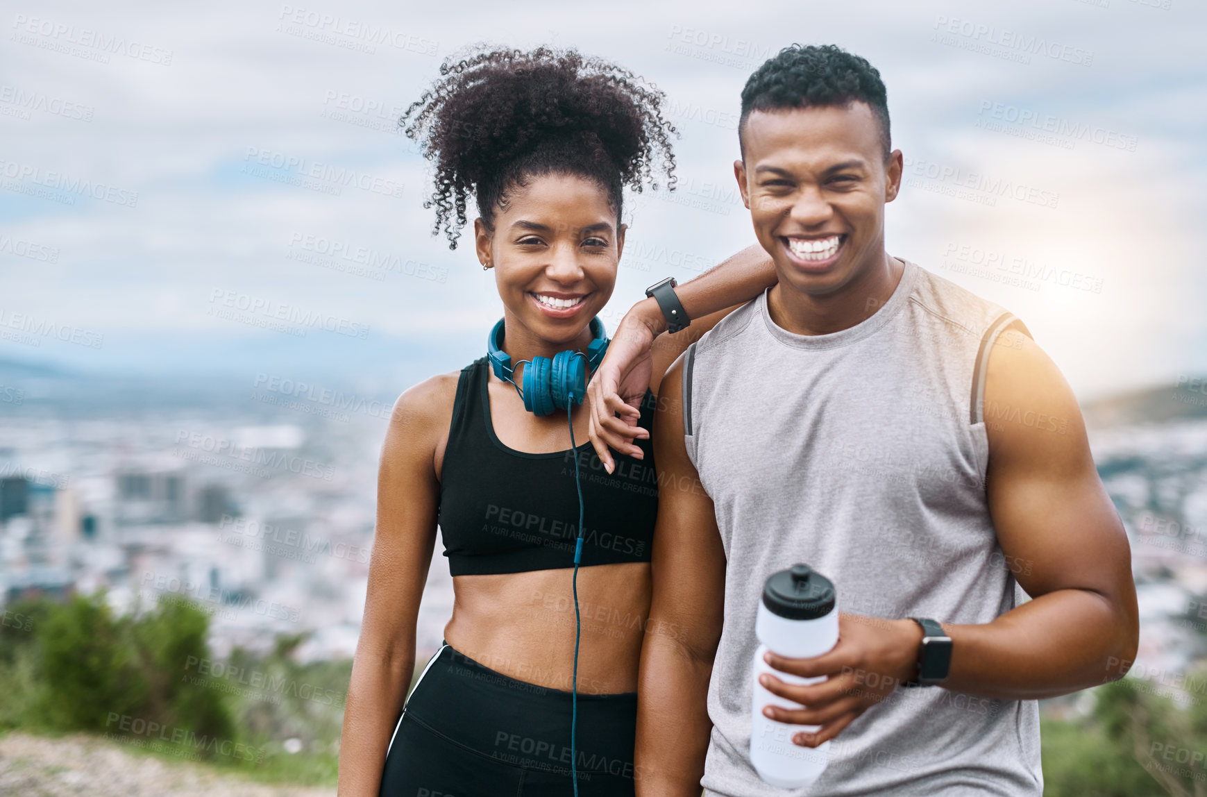 Buy stock photo Portrait of a sporty young couple taking a break while exercising outdoors