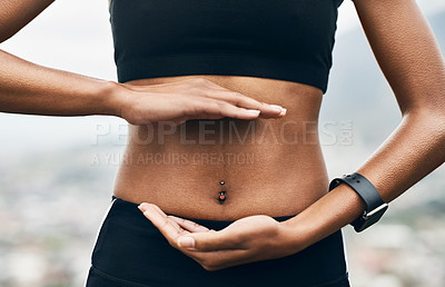 Buy stock photo Closeup shot of a sporty unrecognizable woman holding her hands against her stomach outside
