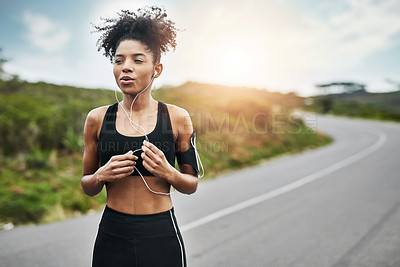 Buy stock photo Shot of a sporty young woman running outdoors