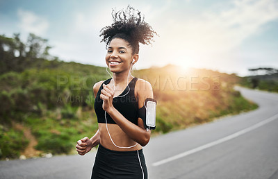 Buy stock photo Sports, portrait and happy woman running in road with music earphones, workout or cardio routine. Smile, exercise and face of female runner in nature with podcast for training, energy and fitness 