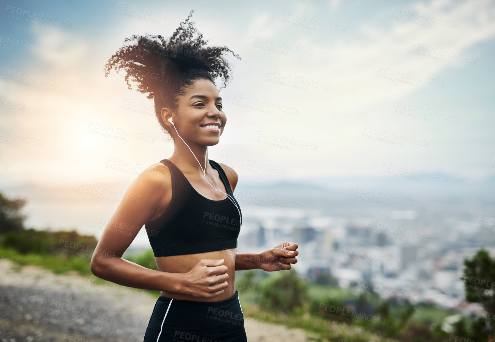 Buy stock photo Shot of a sporty young woman running outdoors