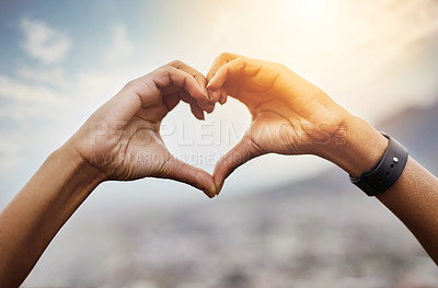 Buy stock photo Closeup shot of an unrecognizable couple making a heart shape with their hands outdoors