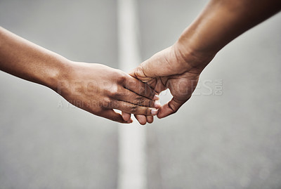 Buy stock photo Closeup shot of an unrecognizable couple holding hands together outdoors