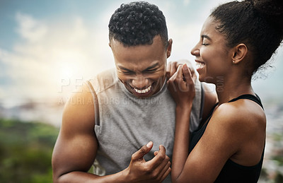 Buy stock photo Shot of a sporty young couple exercising together outdoors