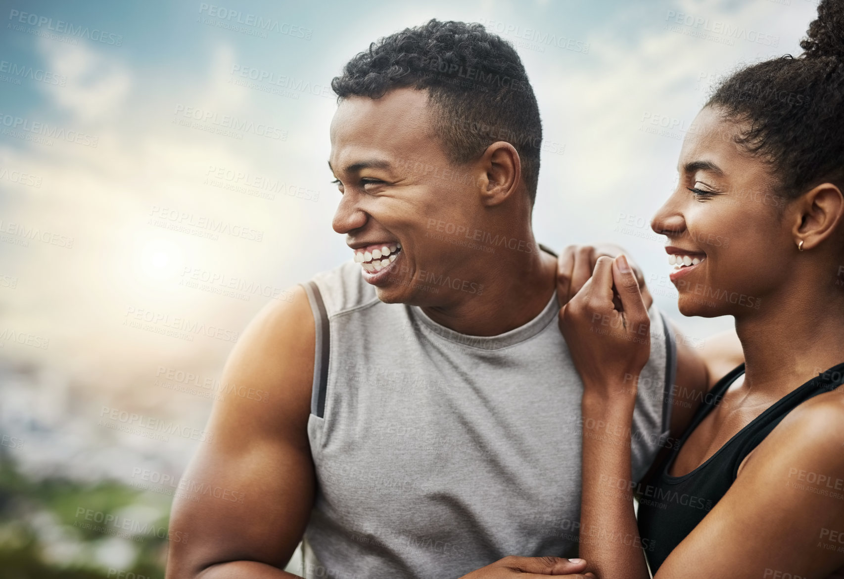 Buy stock photo Shot of a sporty young couple exercising together outdoors