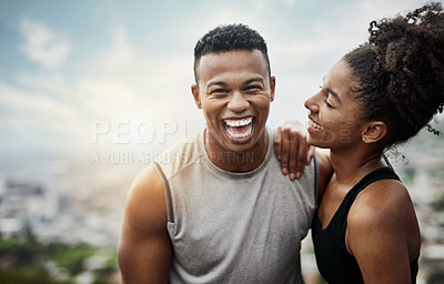 Buy stock photo Shot of a sporty young couple exercising together outdoors