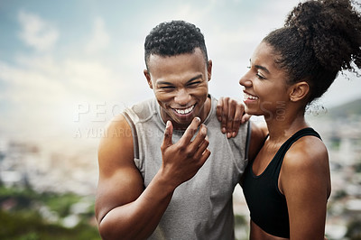 Buy stock photo Shot of a sporty young couple exercising together outdoors