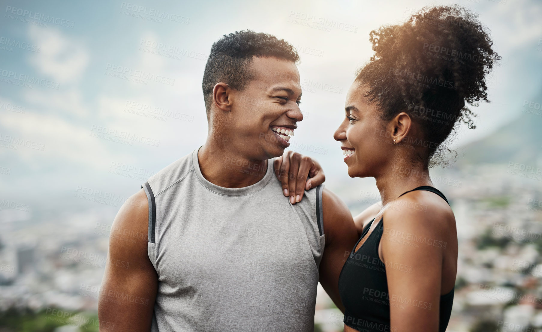 Buy stock photo Shot of a sporty young couple exercising together outdoors