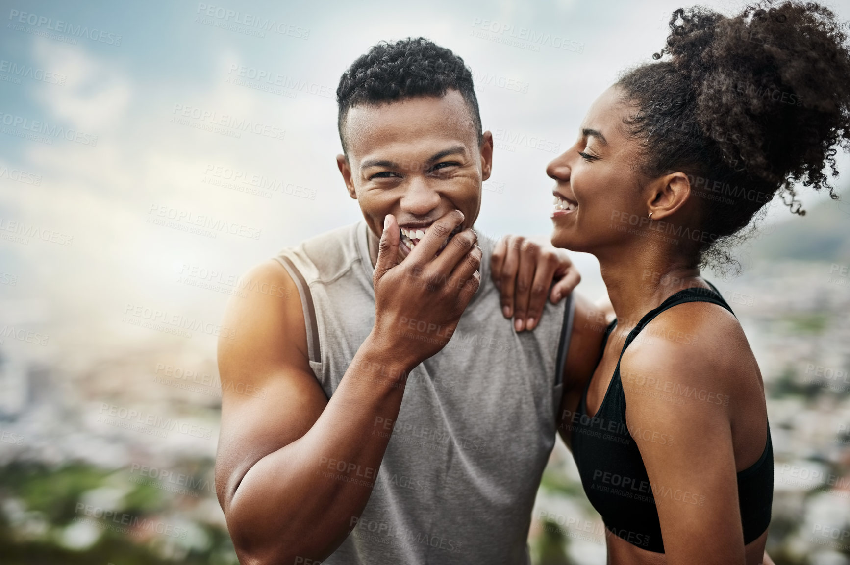 Buy stock photo Shot of a sporty young couple exercising together outdoors