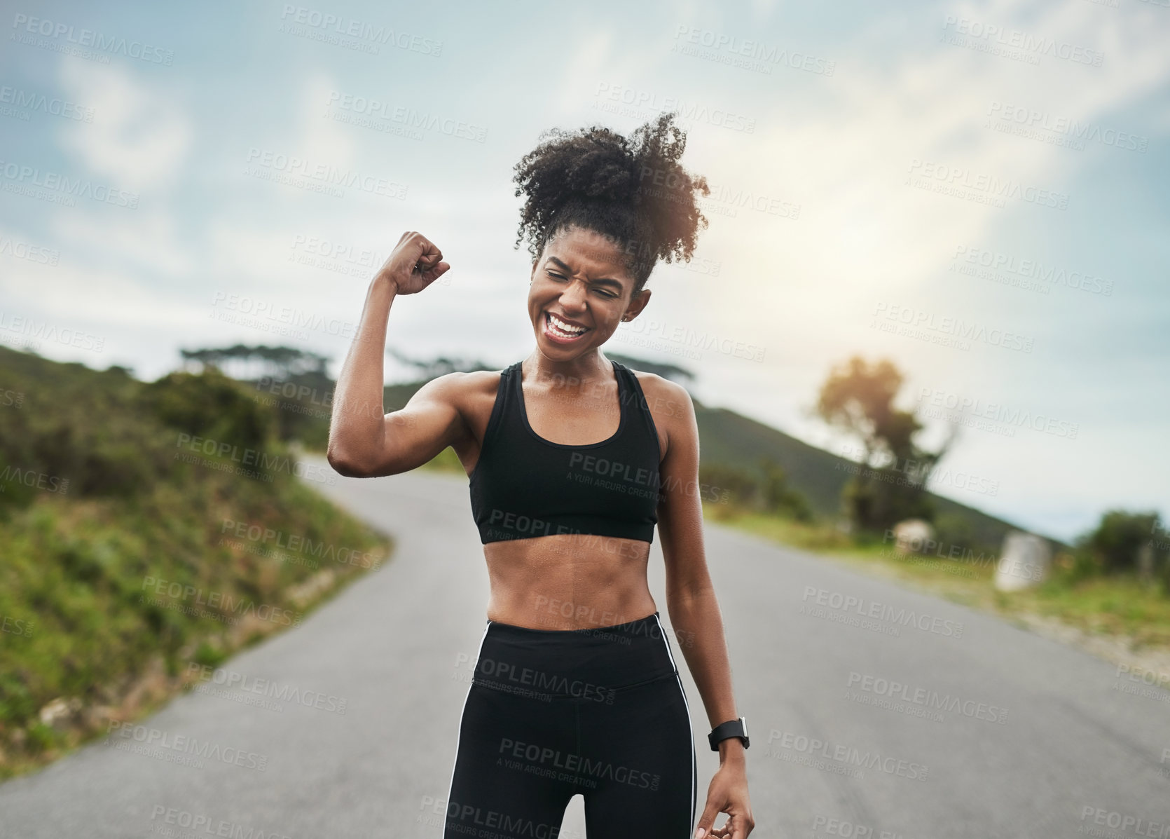 Buy stock photo Cropped shot of an attractive young sportswoman flexing her bicep outside