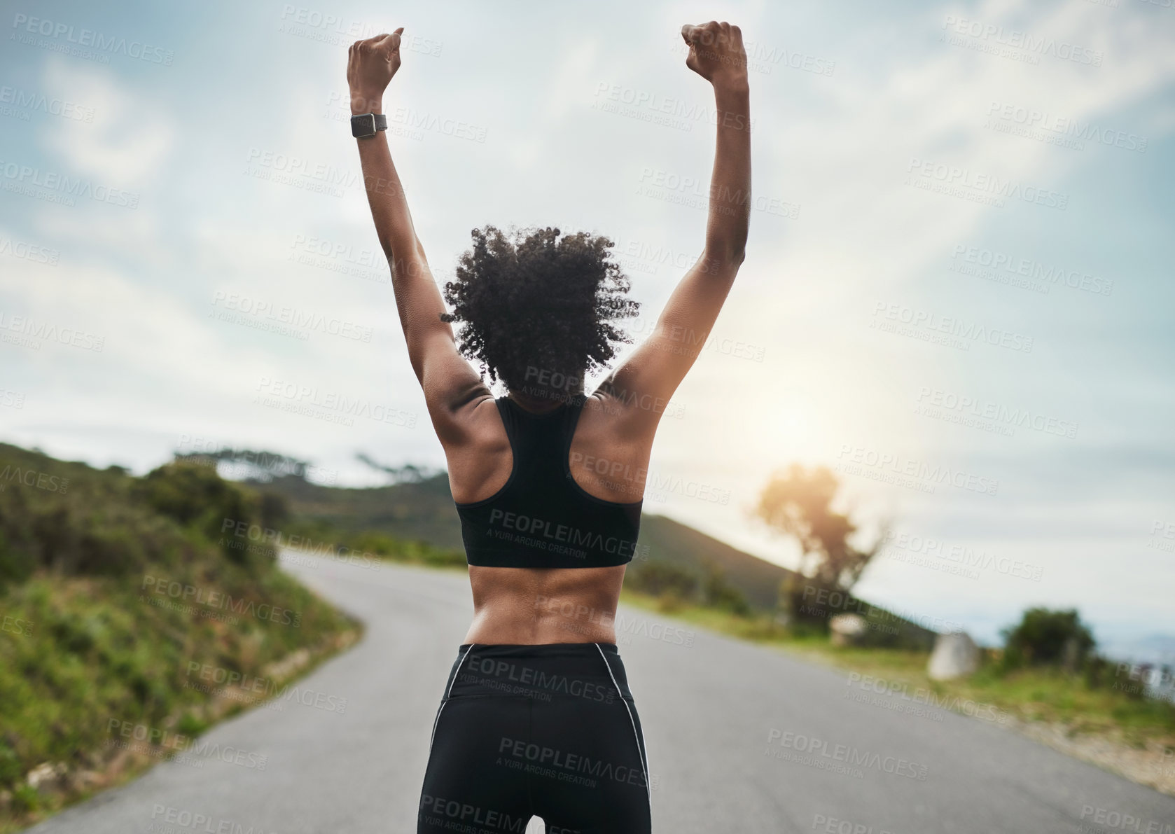 Buy stock photo Woman, runner and victory or back in road, celebration and arm for achievement or fitness or body goals. Outside, marathon training and cardio exercise with athlete, first pump and proud wellness