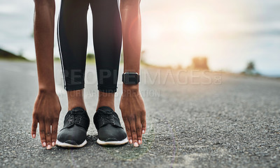 Buy stock photo Cropped shot of an unrecognizable young sportswoman warming up for a workout outdoors
