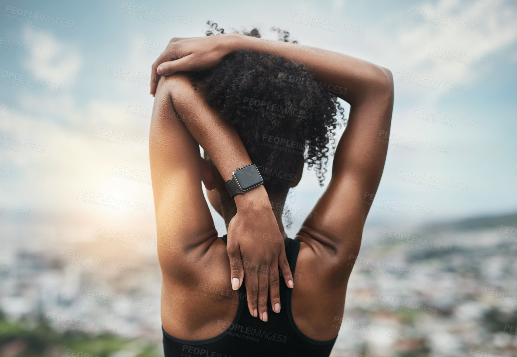 Buy stock photo Rearview shot of an unrecognizable young sportswoman warming up for a workout outdoors