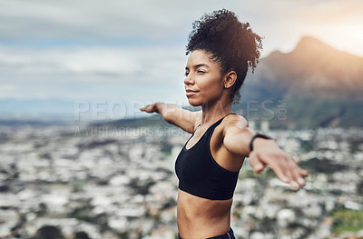 Buy stock photo Cropped shot of an attractive young sportswoman warming up for a workout outdoors