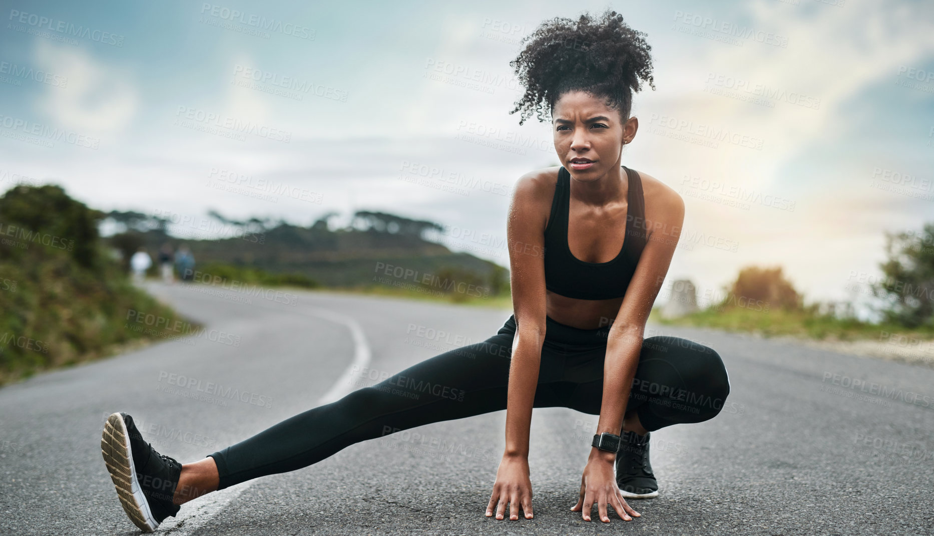 Buy stock photo Full length shot of an attractive young sportswoman warming up for a workout outdoors