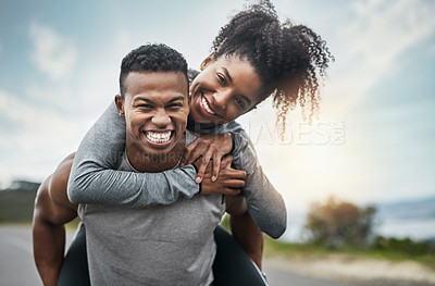 Buy stock photo Cropped portrait of a handsome young sportsman piggybacking his athletic young girlfriend outside