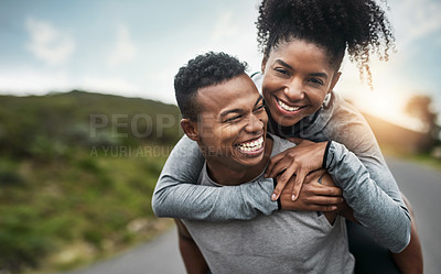 Buy stock photo Cropped shot of a handsome young sportsman piggybacking his athletic young girlfriend outside