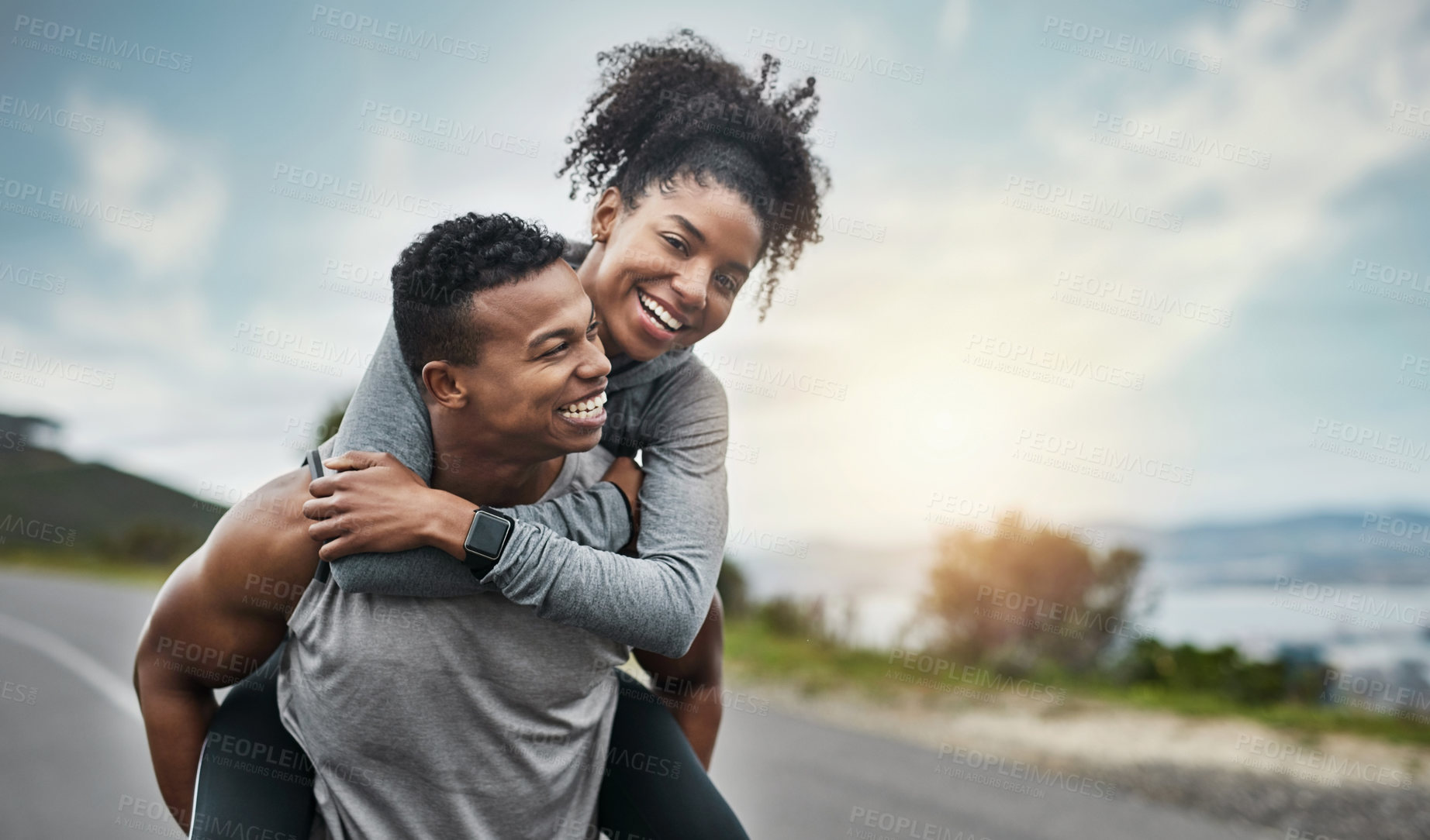 Buy stock photo Cropped shot of a handsome young sportsman piggybacking his athletic young girlfriend outside