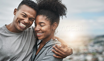 Buy stock photo Cropped shot of an affectionate and athletic young couple standing with their arms around one another outdoors