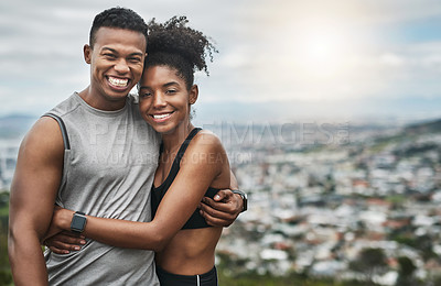 Buy stock photo Cropped portrait of an affectionate and athletic young couple standing with their arms around one another outdoors