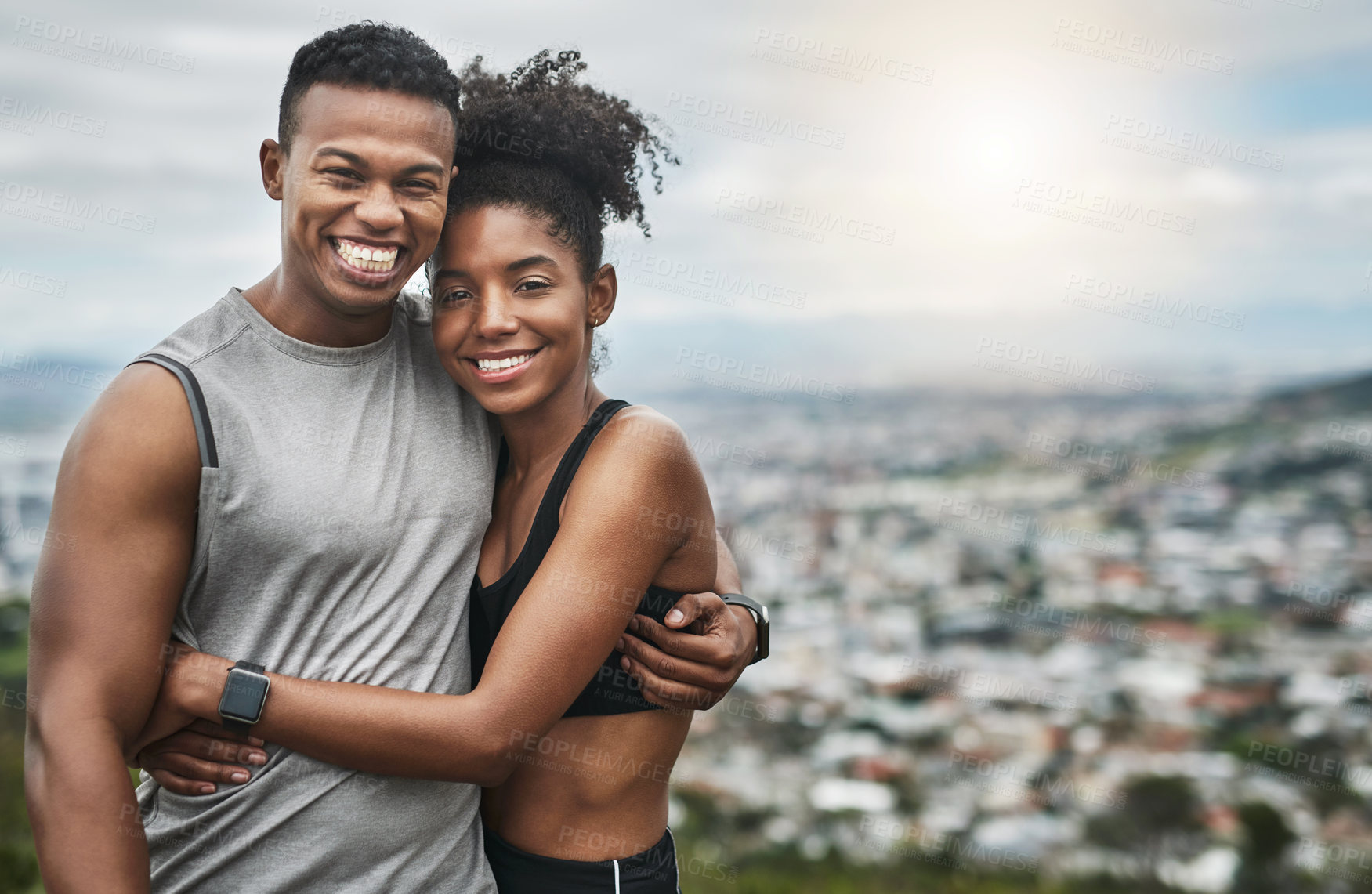 Buy stock photo Cropped portrait of an affectionate and athletic young couple standing with their arms around one another outdoors