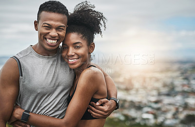 Buy stock photo Cropped portrait of an affectionate and athletic young couple standing with their arms around one another outdoors