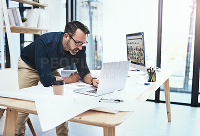 Buy stock photo Frustrated, mature man and architect with laptop and blueprints for building planning and design problem. Senior, male engineer and computer with documents for panic or stress at project deadline