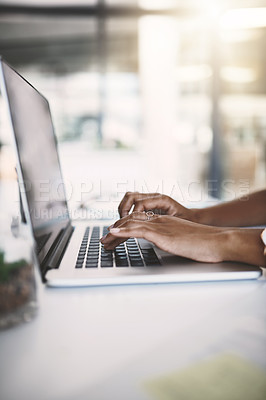 Buy stock photo Cropped shot of a businesswoman using a laptop at her desk in a modern office