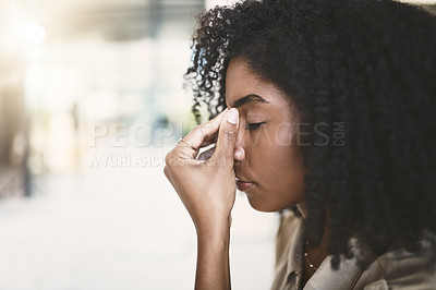 Buy stock photo Shot of a young businesswoman looking stressed at work