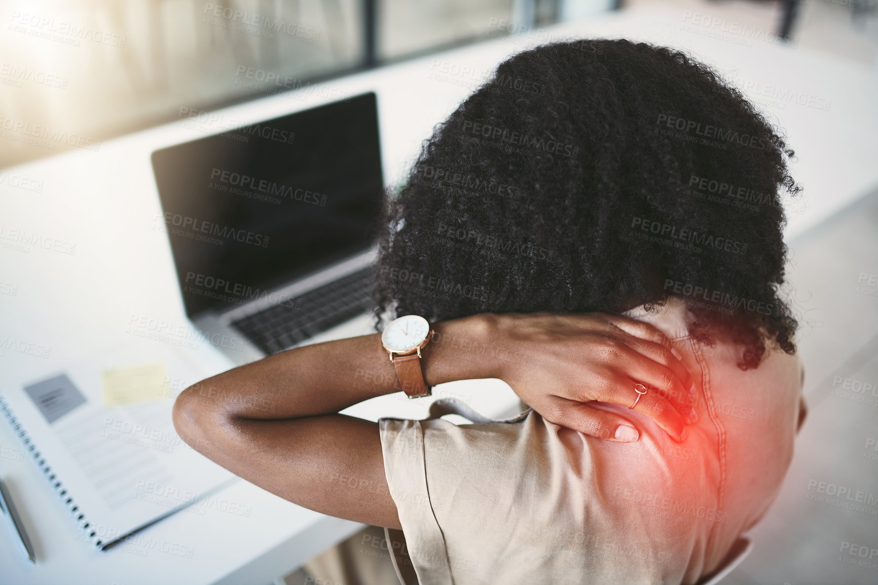 Buy stock photo Shot of a young businesswoman experiencing back pain while working in a modern office