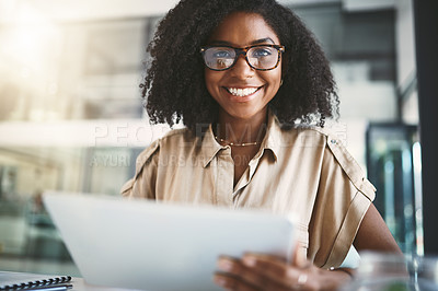 Buy stock photo Portrait of a young businesswoman using a digital tablet in a modern office