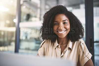 Buy stock photo Portrait of a young businesswoman using a laptop at her desk in a modern office