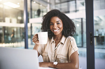 Buy stock photo Portrait of a young businesswoman using a laptop and drinking coffee at her desk in a modern office