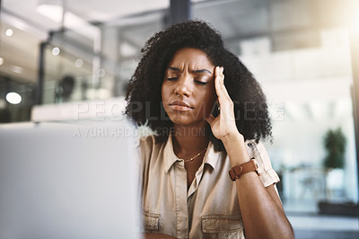 Buy stock photo Shot of a young businesswoman looking stressed at her desk in a modern office