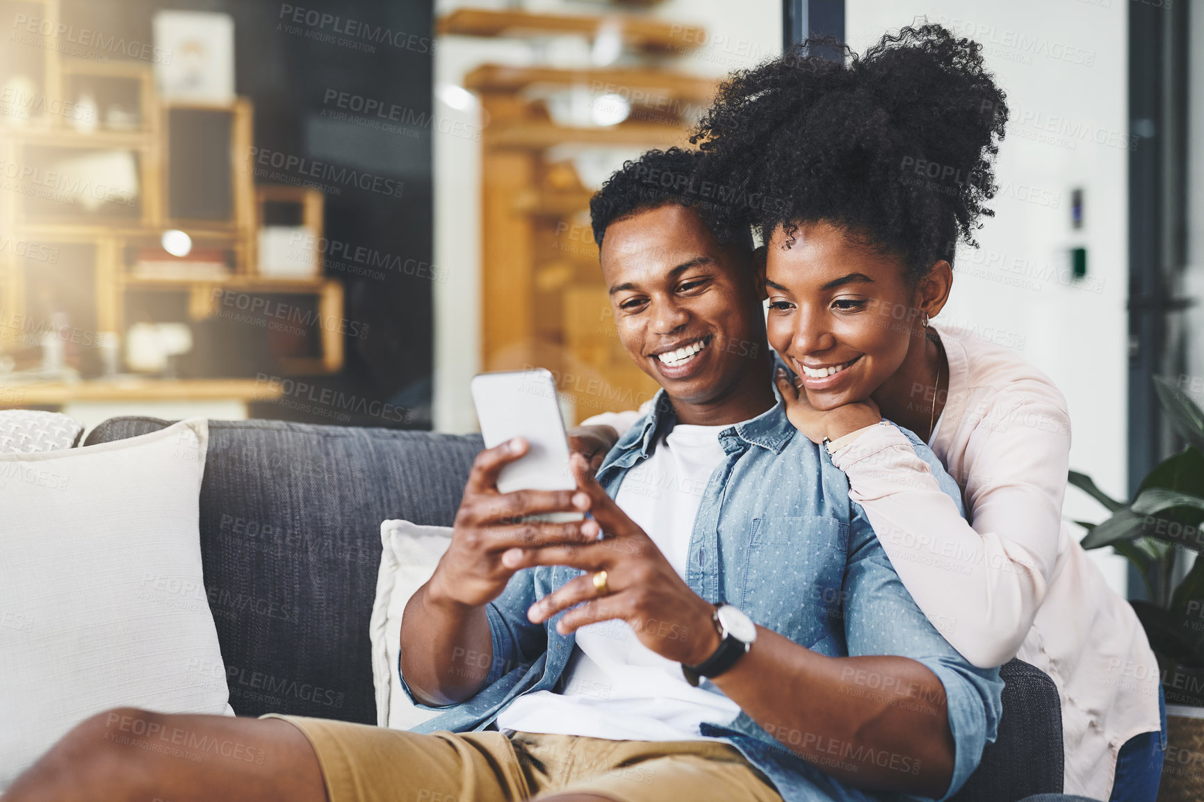 Buy stock photo App, phone and social media with black couple on sofa in home living room together to relax. Communication, happy or wellness with smile of man and woman in apartment for online shopping or streaming