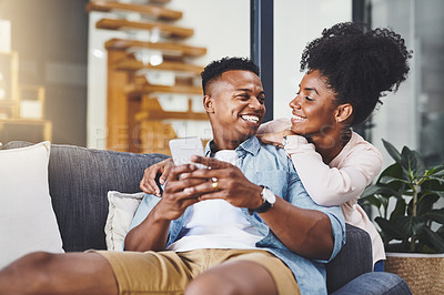 Buy stock photo Communication, phone and social media with black couple on sofa in home living room together to relax. App, happy or wellness with smile of man and woman in apartment for online shopping or streaming