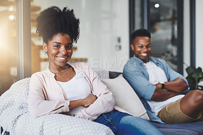 Buy stock photo Shot of a happy young couple relaxing together on the sofa at home