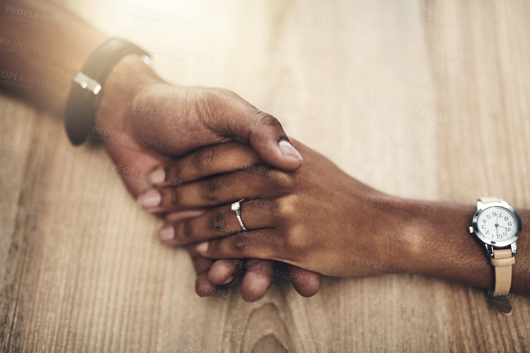 Buy stock photo Cropped high angle shot of a man and woman holding hands at a table