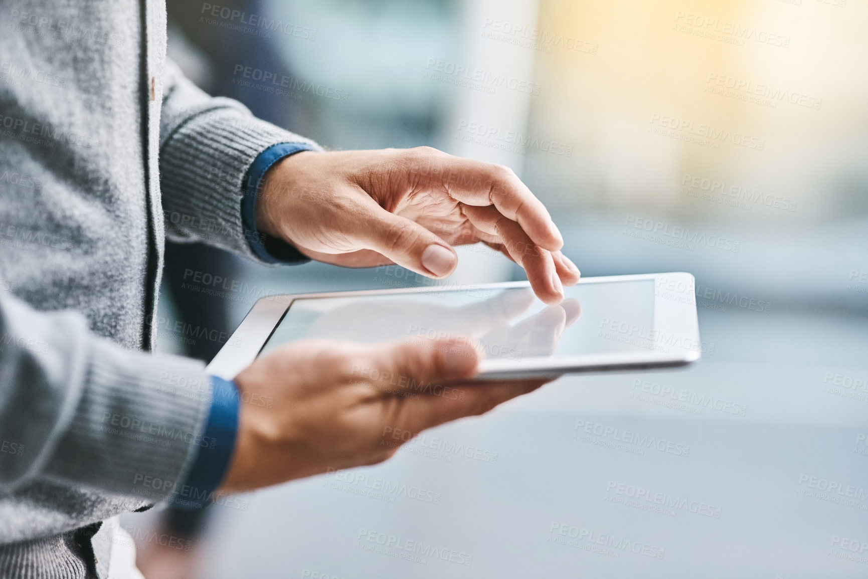 Buy stock photo Closeup shot of an unrecognizable businessman using a digital tablet in an office