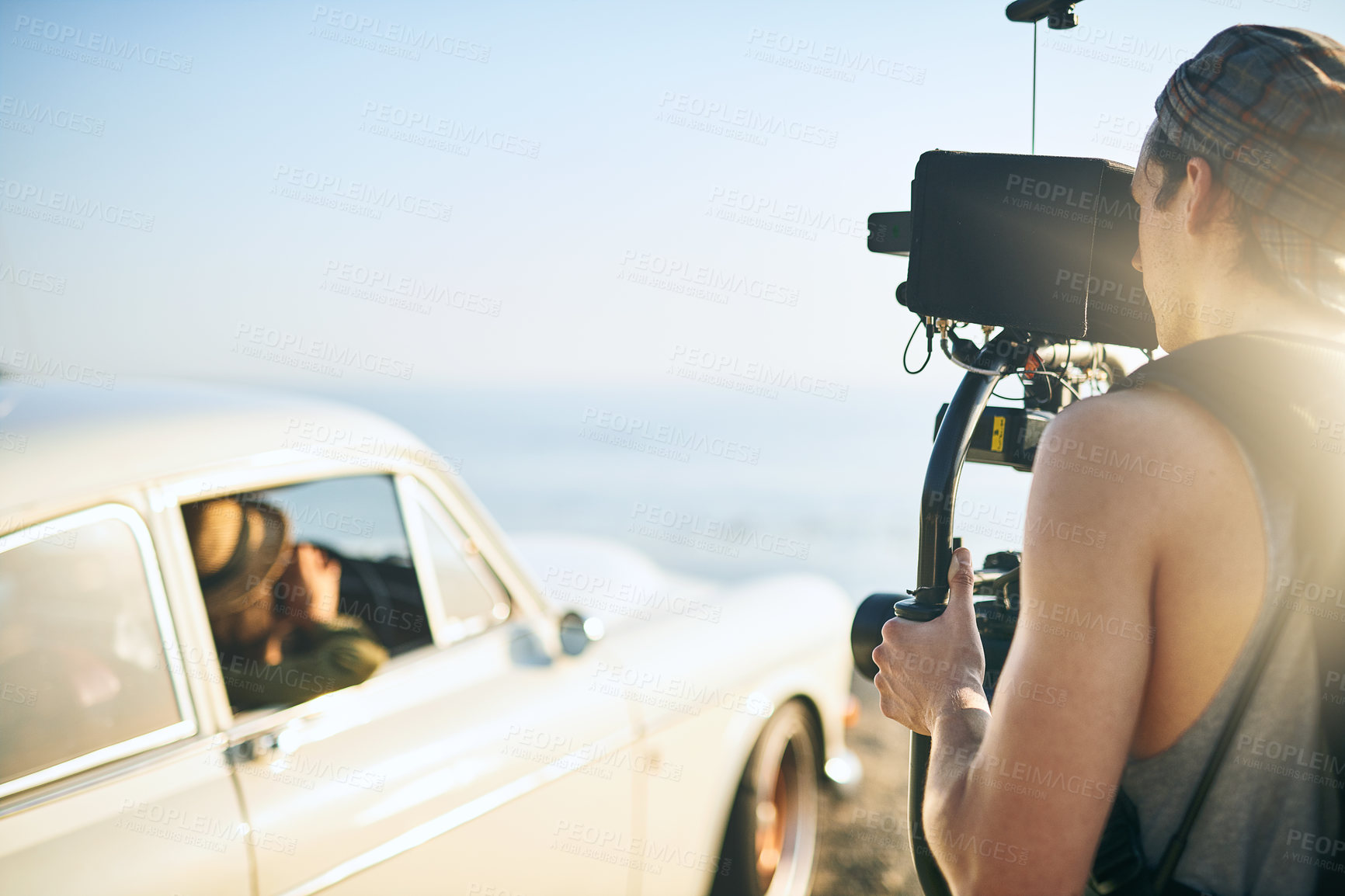 Buy stock photo Videographer, camera and retro car for beach photoshoot, video analysis or travel documentary filming. Production process, person and recording for nature, movie or filmmaking with professional gear