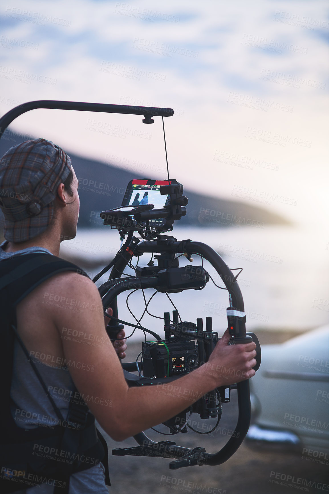 Buy stock photo Filmmaker, camera and car for sunset cruise photoshoot, video analysis or travel documentary. Production process, person or recording for beach, movie or videography with professional filming gear