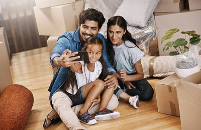 Buy stock photo Cropped shot of an affectionate young family taking selfies while moving house